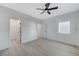 A simple bedroom design with neutral walls, a ceiling fan, a window, and a walk-in closet at 11119 Cantoria Ct, Las Vegas, NV 89141