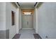 Inviting entryway with a double door entrance and textured stucco walls, leading to a bright interior at 11119 Cantoria Ct, Las Vegas, NV 89141