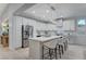 Stylish kitchen with stainless steel appliances, a large island with seating, and modern pendant lighting at 11119 Cantoria Ct, Las Vegas, NV 89141