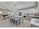 Modern kitchen with large island, stainless steel appliances, pendant lighting, and opens to the living room at 11119 Cantoria Ct, Las Vegas, NV 89141