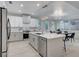 Open-concept kitchen with island, stainless steel appliances, and adjacent dining area bathed in natural light at 11119 Cantoria Ct, Las Vegas, NV 89141