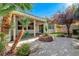 Covered patio with palm trees and lush greenery, perfect for outdoor entertaining at 11119 Cantoria Ct, Las Vegas, NV 89141