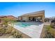 Expansive backyard with pool, covered patio, and manicured landscaping, perfect for outdoor living at 1143 Tortoise Mountain Dr, Mesquite, NV 89034