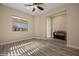 Airy bedroom with ceiling fan, large window, light gray flooring, and adjacent entryway at 1143 Tortoise Mountain Dr, Mesquite, NV 89034