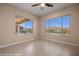 A bedroom with lots of light from the two windows overlooking the landscaped backyard at 1143 Tortoise Mountain Dr, Mesquite, NV 89034