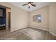 Bright bedroom featuring modern ceiling fan, neutral walls, and light gray wood-look flooring at 1143 Tortoise Mountain Dr, Mesquite, NV 89034