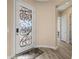 Elegant foyer with decorative glass door, hardwood floors, and neutral wall colors at 1143 Tortoise Mountain Dr, Mesquite, NV 89034