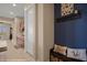 Inviting hallway features tile flooring, neutral paint, and a charming bench with decorative pillows at 1143 Tortoise Mountain Dr, Mesquite, NV 89034