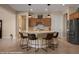 Beautiful kitchen island with barstool seating, stainless steel appliances, and warm wood cabinetry at 1143 Tortoise Mountain Dr, Mesquite, NV 89034