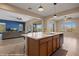 Spacious kitchen island overlooking the living room, featuring granite countertops and stainless steel dishwasher at 1143 Tortoise Mountain Dr, Mesquite, NV 89034