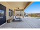 Covered patio featuring seating area with lounge chairs, ceiling fan, and barbecue for outdoor enjoyment at 1143 Tortoise Mountain Dr, Mesquite, NV 89034