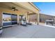 Relaxing covered patio with ceiling fans, lounge chairs, and sliding glass doors for indoor-outdoor living at 1143 Tortoise Mountain Dr, Mesquite, NV 89034