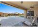 Backyard view showcasing the pool, and covered patio with lounge chairs, perfect for entertaining at 1143 Tortoise Mountain Dr, Mesquite, NV 89034