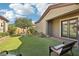 Private backyard with artificial turf and sitting area at 248 N Milan St, Henderson, NV 89015