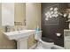 Powder room with pedestal sink and dark accent wall at 248 N Milan St, Henderson, NV 89015