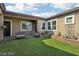 Private courtyard with artificial turf, seating area, and potted plants at 248 N Milan St, Henderson, NV 89015