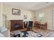 Cozy living room with fireplace and adjacent dining area at 248 N Milan St, Henderson, NV 89015