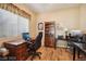 Home office with built-in wooden shelving and hardwood floors at 248 N Milan St, Henderson, NV 89015