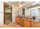 Elegant bathroom with double vanity, copper sinks, and a large walk-in shower at 5024 Crown Cypress St, Las Vegas, NV 89149