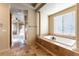 Spa-like bathroom with soaking tub and tile flooring at 5024 Crown Cypress St, Las Vegas, NV 89149