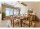 Virtually staged dining room with a rustic wooden table and striped chairs at 5024 Crown Cypress St, Las Vegas, NV 89149