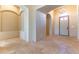 Elegant entryway with high ceilings, arched niches, and beige tile flooring at 5024 Crown Cypress St, Las Vegas, NV 89149