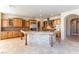 Gourmet kitchen with wood cabinets, granite counters, and large island at 5024 Crown Cypress St, Las Vegas, NV 89149