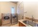 Laundry room with stainless steel sink and granite countertop at 5024 Crown Cypress St, Las Vegas, NV 89149