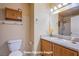 Clean bathroom with wood cabinets and a large mirror at 5123 Mascaro Dr, Las Vegas, NV 89122