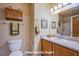 Bathroom with wood cabinets, a toilet, and a shower at 5123 Mascaro Dr, Las Vegas, NV 89122