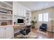 Home office with built-in shelving, a desk, and comfortable seating at 5123 Mascaro Dr, Las Vegas, NV 89122