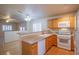 Kitchen with wood cabinets, granite countertops, and a breakfast bar at 5123 Mascaro Dr, Las Vegas, NV 89122