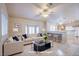 Living room features a beige couch, coffee table, and kitchen bar at 5123 Mascaro Dr, Las Vegas, NV 89122