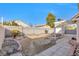 Large backyard with rock landscaping, storage shed, and patio area at 5125 Coral Beach St, North Las Vegas, NV 89031