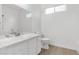 Clean bathroom with single vanity, marble countertop, and shower/tub at 5125 Coral Beach St, North Las Vegas, NV 89031