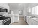 Modern kitchen with stainless steel appliances and white cabinets at 5125 Coral Beach St, North Las Vegas, NV 89031