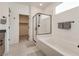 Clean bathroom with soaking tub and glass shower enclosure at 540 Front Range Ln, North Las Vegas, NV 89084