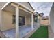 Covered patio with artificial turf and gravel landscaping at 540 Front Range Ln, North Las Vegas, NV 89084