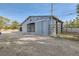 Gray barn with sliding doors and adjacent paddock at 7000 W Rome Blvd, Las Vegas, NV 89131