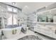 Modern bathroom with a soaking tub, double vanity and large mirror at 7000 W Rome Blvd, Las Vegas, NV 89131