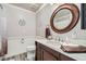 Traditional bathroom with a classic vanity and wood-framed mirror at 7000 W Rome Blvd, Las Vegas, NV 89131