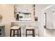 Kitchen breakfast bar with two stools, view of kitchen and hallway at 7000 W Rome Blvd, Las Vegas, NV 89131