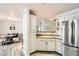 Kitchen with white cabinets, granite countertops and breakfast bar at 7000 W Rome Blvd, Las Vegas, NV 89131