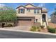 Charming two-story home with a two-car garage, stone accents, and a well-manicured front yard at 7914 Torreys Peak St, Las Vegas, NV 89166