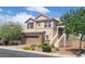 Beautiful two-story home with stone accents, a two-car garage, mature trees, and desert-friendly landscaping at 7914 Torreys Peak St, Las Vegas, NV 89166