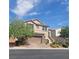 Two-story house with a brown garage door and landscaped yard at 7914 Torreys Peak St, Las Vegas, NV 89166