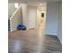 Bright hallway with laminate wood flooring and access to laundry at 7914 Torreys Peak St, Las Vegas, NV 89166