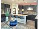 Modern kitchen with island, dark cabinets and stainless steel appliances at 7914 Torreys Peak St, Las Vegas, NV 89166