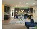 Modern kitchen with dark cabinetry, glass-top table, and island at 7914 Torreys Peak St, Las Vegas, NV 89166