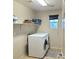 Laundry room with washer, dryer, shelving and window at 7914 Torreys Peak St, Las Vegas, NV 89166